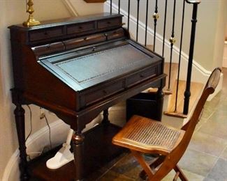 Writing desk and caned folding chair