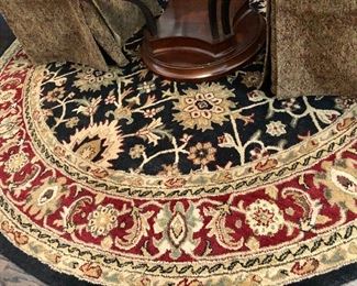 8' round black/burgundy rug