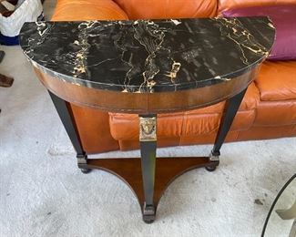 Louis XVI inspired table with black marble top and figural heads