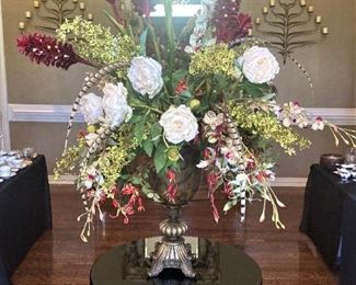 One of many large floral arrangements; round table with black velvet cloth