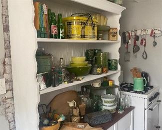 Pyrex, vintage glass bottles, cookbooks, canisters, tins, pottery, pitcher and mug set, cutting boards, kitchen utensils, stove, hutch, enamel, vintage