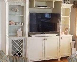 Built in cabinetry houses an entertainment center/wine bar 