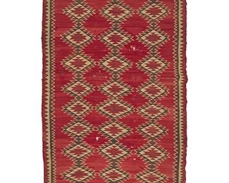 2013
A Large Ganado-Style Navajo Rug
Mid-20th Century; Diné
Woven in red, brown, and cream wool with three columns of conjoined serrated diamonds, with a double sawtooth border to two sides
93" L x 66" W
Estimate: $300 - $500