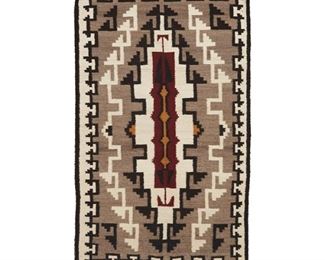 2015
A Navajo Klagetoh Rug
Second Half 20th Century; Diné
Woven in grey, black, cream, ochre, and red wool with a narrow central stepped diamond and stepped hatched border to all sides
57" H x 33" W
Estimate: $400 - $600