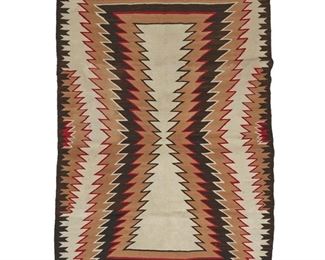 2028
A Navajo Regional Rug
Mid-20th Century; Diné
Woven in red, tan, cream, and dark brown wool with a central concentric serrated hourglass motif and complex serrated borders to two sides
68" H x 52.5" W
Estimate: $300 - $500