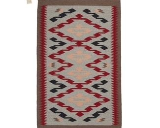 2031
Anna Yellowhair (20th Century, Diné)
A Navajo regional rug
Woven in red, grey, black, cream and dark grey wool with a conjoined diamond motif and red serrated edges
42.5" H x 27" W
Estimate: $300 - $500