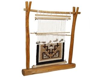 2041
A Loom With A Navajo Two Grey Hills Weaving Sample
Fourth-Quarter 20th Century; Diné
Comprised of a loom formed from two natural wood branches, with a Two Grey Hills weaving sample attached
21.75" H x 20" W x 4.5" D
Estimate: $200 - $400
