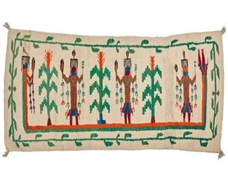2053
A Navajo Yei Weaving
Mid-20th Century or later; Diné
Woven in green, brown, orange, blue, red, grey, and cream wool with three standing figures and three corn stalks surrounded by a Rainbow Guardian, with a vine border
38" H x 65" W
Estimate: $300 - $500