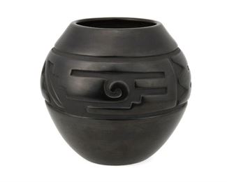 2063
LuAnn Tafoya (B. 1938, Santa Clara Pueblo)
A blackware vessel
Signed to underside: LuAnn Tafoya / Santa Clara Pue [sic] / N.M.
A low shoulder pot with a carved geometric band on a black burnished slip glaze
7.5" H x 8.25" Dia.
Estimate: $800 - $1,200