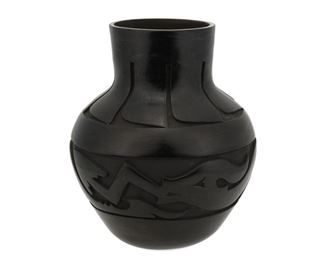 2064
Mida Tafoya (B. 1931, Santa Clara Pueblo)
A blackware vase
Signed to underside: Mida Tafoya / Santa Clara Pueblo
A tall vase with deep carved Avanyu serpent motif and carving to neck
11" H x 9" Dia.
Estimate: $300 - $500