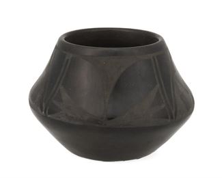 2065
Carmelita Dunlap (1925-1999, San Ildefonso Pueblo)
A blackware pot
Signed to underside: Carmelita Dunlap / San Ildefonso Pueblo
A low shoulder pot with a matte geometric band on black burnished slip glaze
4" H x 6" Dia.
Estimate: $200 - $300