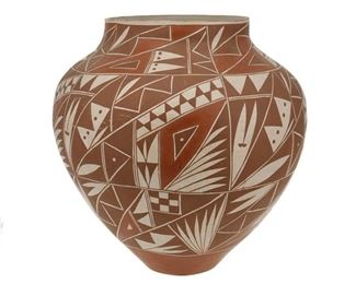 2075
An Acoma Polychrome Pottery Olla
20th Century; Acoma Pueblo
Marked to underside: Salvador / Acoma / NM
A large pottery olla with geometric designs in browns, terracotta and white slip glaze
16" H x 15.5" Dia.
Estimate: $300 - $500