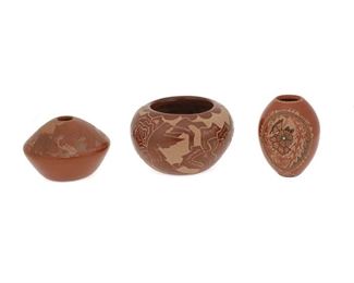 2082
A Group Of Pueblo Sgraffito Pottery Vessels
Three works:

A Gwen Tafoya sgraffito pottery bowl
(b. 1965, Santa Clara Pueblo)
Signed: Gwen Tafoya / SCP
The red burnished slip glaze bowl with sgraffito flowers and hummingbirds
3.5" H x 5.5" Dia.

A Glendora Fragua sgraffito pottery seed pot
(b. 1958, Jemez Pueblo)
Signed with artist's cornstalk cipher
The ovoid, red burnished slip glaze seed pot with sgraffito geometric motifs and centering a reserve with flowers and butterflies set with a turquoise
4" H x 3" Dia.

A Roy Tsigowanu sgraffito pottery seed pot
(b. 1957, San Juan Pueblo)
Signed and dated: Tsigowanu / Kwa Povi / 6-5-85
The wide shouldered, red burnished slip glaze seed pot with sgraffito bears in a landscape
3.25" H x 4.25" Dia.

3 pieces
Estimate: $400 - $600