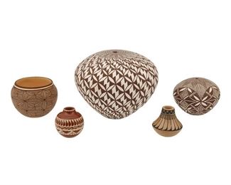 2079
Five Puebloan Pottery Vessels
Five works:

A Livia Roxanne Panteah Zuni bowl
20th Century; Zuni
Signed and dated to underside: Livia Roxanne Panteah / Zuni / -1994-
With brown fineline star burst pattern on a buff ground
2.25" H x 3" Dia.

An Ursula Curran Santa Clara/San Juan Pueblo miniature jar
(b.1979, Santa Clara/San Juan Pueblo)
Signed and dated to underside: Ursula Curran / Santa Clara / San Juan
The redware jar with burnished red slip glaze and matte cream slip painted Avanyu serpent and feather border
1.75" H x 1.75" Dia.

A Crucita "Blue Corn" Calabaza San Ildefonso Pueblo miniature jar
(1921-1999, San Ildefonso Pueblo)
Signed to underside: Blue Corn / San Ildefonso [illegible]
The miniature, wide-shouldered jar with burnished buff slip glaze and matte slip painted feather pattern
1.75" H x 1.75" Dia.

An Acoma Pueblo pottery seed pot
Second Half 20th Century
Signed to underside: Acoma / NM / Paula [possibly Paula Chino]
The brown-on-white pottery vessel with brown butte