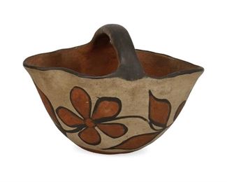 2090
A Santo Domingo Pueblo Pottery Basket
Circa 1923
Signed and dated illegibly in pencil to underside
The polychrome pottery vessel with floral vine on buff slip glaze
4.75" H x 6.5" W x 5.125" D
Estimate: $100 - $200