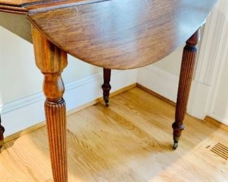 Drop leaf table with fluted legs on casters