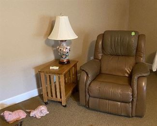 View of recliner, table, and lamp