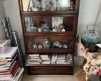 This is a barrister's bookcase, housing a number of different decorative pieces.