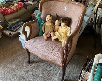 These three dolls are obviously friends, sharing a chair.