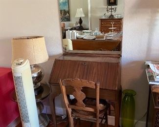 Central in this picture is the writing desk and chair. Also a fan.