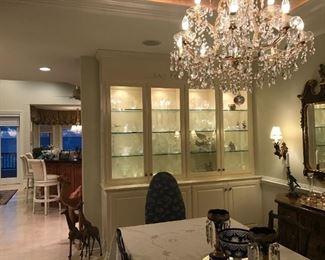 lighted cabinet filled with multiple pieces of crystal