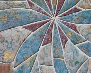close-up of mosaic design on glass-top round table