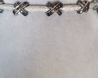 Black and White "X" Diamond Bracelet stamped and tested 18K in white gold.  140 pave' set black diamonds on the "X" at 1.12 ctw.  220 White diamonds at 1.10 ctw on the bar links.