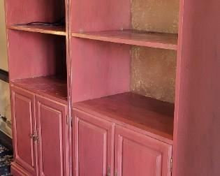 Bookcase with red painted exterior and gold painted backing on bun feet.  Two cases as one on bun feet, 17" deep x 30" wide x 79" tall