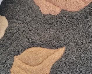 Close up of carved beach-themed rug