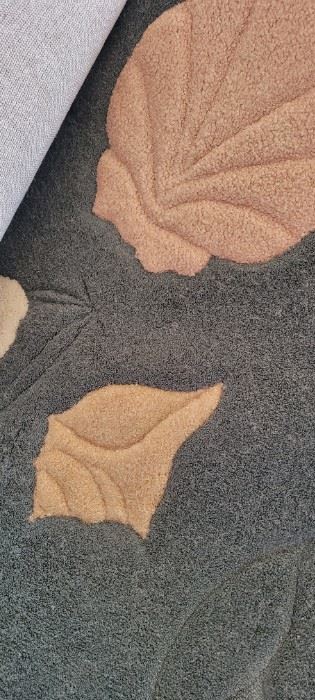 Close up of carved beach-themed rug