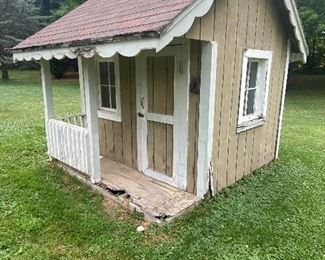 Adorable Children's Playhouse measuring about 10' x 9". Includes a small interior loft and a kitchen play set. 

Please note, sold in as-is condition with some wear including some wood rot and paint loss. Will need a few repairs.  
