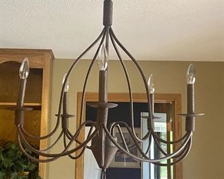 Lovely Five Arm Chandelier with Rustic Cast Finish. Can be displayed three different ways, as pictured, or with coordinating shades placed on the bulbs or white slip covers making a more candle-like appearance. Very nice antique-look finish! Measures about 28" h x 21" w. 