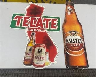 Tecate and Amsteel Light Beer Metal Beer Signs in good condition with light wear. Reproductions. The tallest sign is 25"