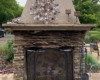 Outdoor Freestanding Wood Burning Fireplace. Wow! Create an oasis in your backyard with this amazing fireplace! In fair condition with some wear consistent with outdoor use including some loose bricks of which are included. Some of the bricks will need repair/reattaching. 

One of the glass front doors is missing, however; a new glass panel is included. Decorations in the photos on the fireplace are not included. Comes with the screen and tools. 

Measures about 48” x 68” x 9’