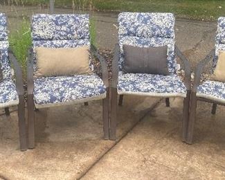 Set of Four Patio Chairs in used condition with wear associated with outdoor use to include some moisture staining on the cushions. 

Measures 24" x 28" x 16" 