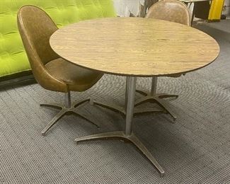 Round Mid Century Table with Pair of Swiveling Chairs in good/used/vintage condtion with some wear including surface marks. Measures 42" round.