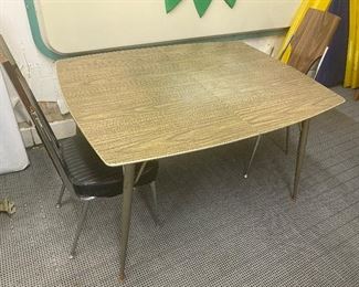 Mid Century Table and Two Chairs Set. Nice table in used/vintage condition with some wear including surface scratches/marks and the vinyl on the seating is loose. Chairs by Chromcraft. 

Table measures 36" x 48". 