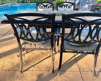 Nice Patio Table and Four Chairs in good condition with some wear consistent with outdoor use. Very nice design! 

Measures 65" x 44" 