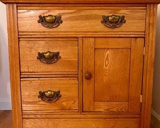 Oak Storage Cabinet With Brass Heart Motif Hardware On Bun Feet
Lot #: 35