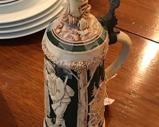 Figure topped stein. Damage to pewter handle.