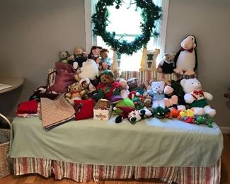 Vintage dolls and stuffed animals on a day bed