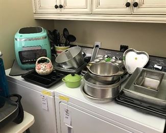 Laundry room with pots and pans and a vintage air fryer