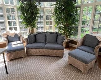 Dragonfly upholstered settle, club chairs, and ottomans. Hexagonal area rug.