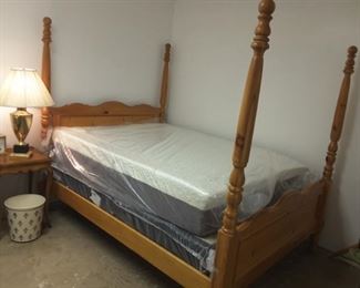 Queen-size Pine four post bed with new mattress set.