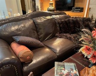 A close look at the leather sofa, faux fur throw and cushions