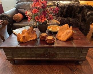 A close look at the rough cut trunk/coffee table, wood bowls, wine bottle holders