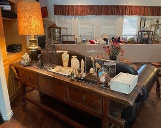 Rough cut sofa table with lots of storage, marble pieces, cloche with butterflies and floral, brass and wood storage box