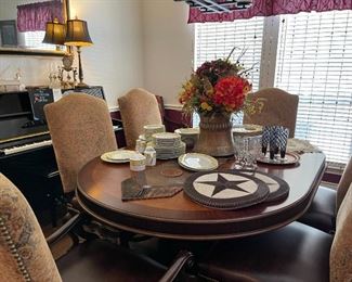 Beautiful dining table with  six high back dining chairs, one with arms.  The table top is beautiful with nice inlay details. Leather place mats and table runner, wonderful floral