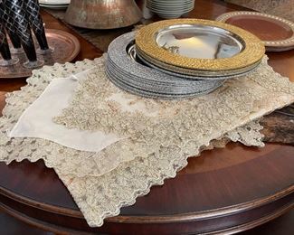A close look at the silver and gold table runners and chargers, just beautiful