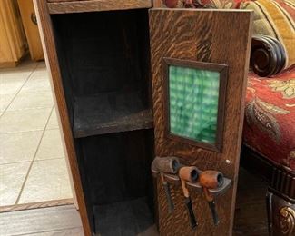 Inside the smoking cabinet with slag glass insert and three pipes